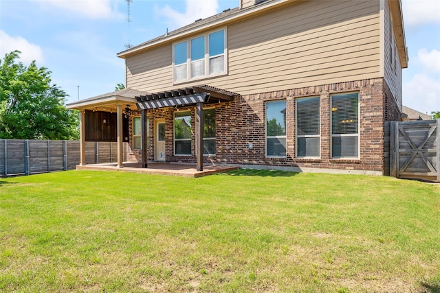 back of property featuring brick siding, a fenced backyard, a pergola, and a patio