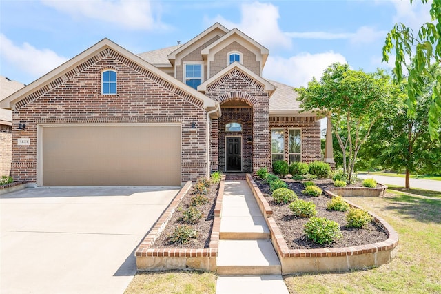 traditional home with brick siding, a garage, roof with shingles, and driveway