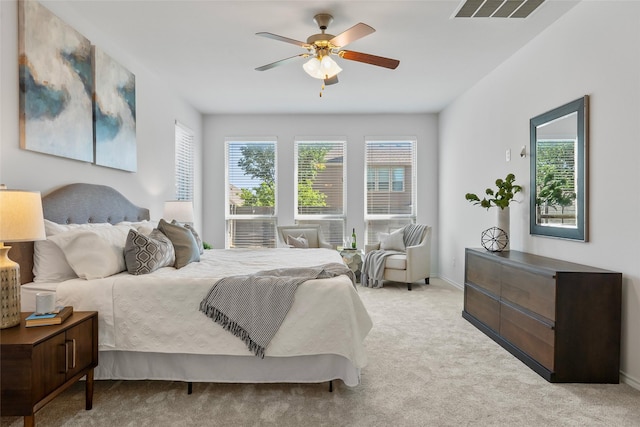 carpeted bedroom with ceiling fan, visible vents, and baseboards