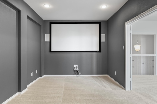 carpeted cinema room with recessed lighting and baseboards
