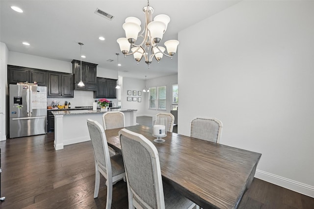dining area featuring dark wood-style floors, baseboards, visible vents, recessed lighting, and a notable chandelier