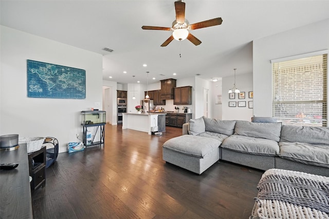 living room with recessed lighting, visible vents, a ceiling fan, and dark wood-style flooring