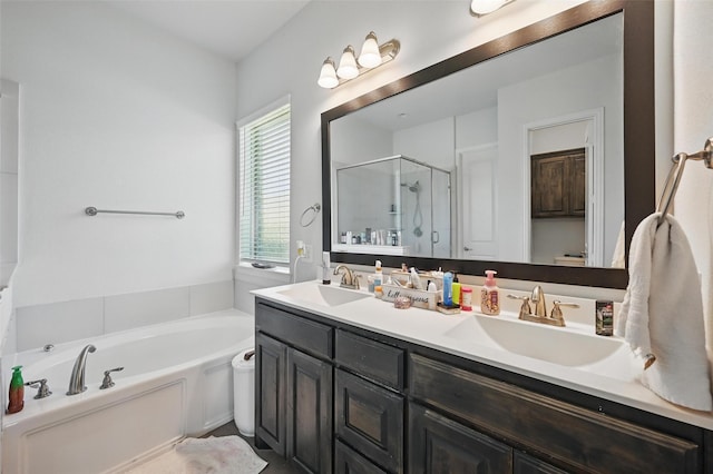 full bath featuring a shower stall, a garden tub, a sink, and double vanity