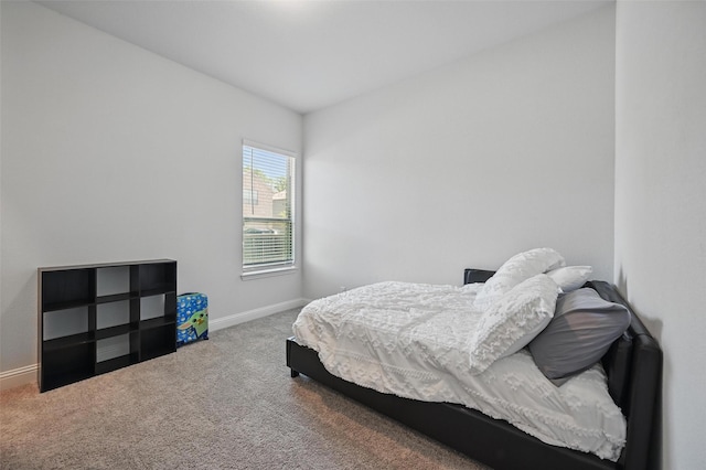 carpeted bedroom featuring baseboards