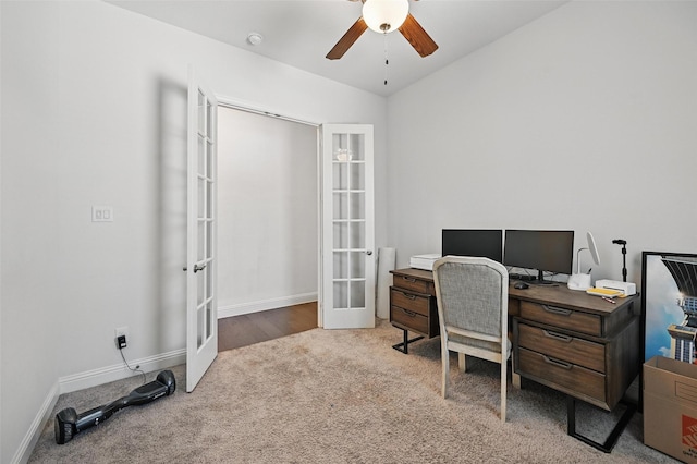carpeted home office with ceiling fan, baseboards, french doors, and vaulted ceiling