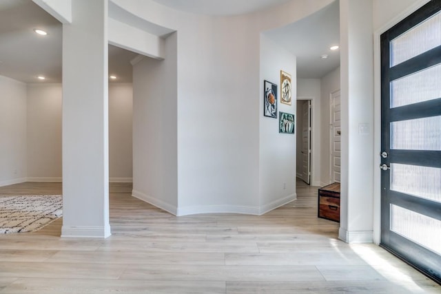 foyer with baseboards, recessed lighting, and light wood-style flooring