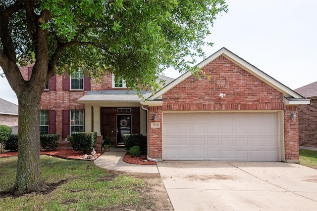 view of front facade featuring an attached garage, a front lawn, and brick siding