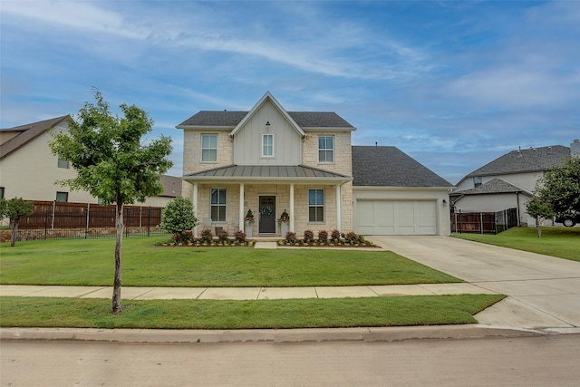 view of front of house featuring concrete driveway, fence, a garage, board and batten siding, and a front yard