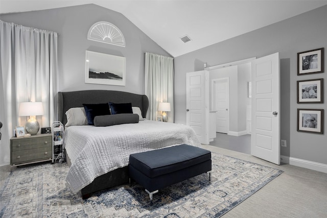 carpeted bedroom with lofted ceiling, baseboards, and visible vents
