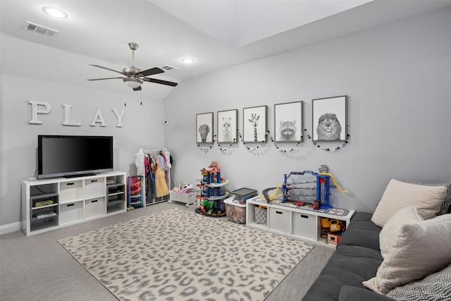 carpeted living room with lofted ceiling, visible vents, a ceiling fan, and baseboards