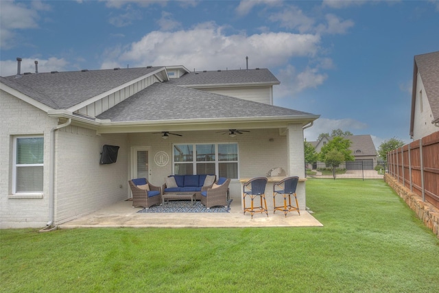 rear view of property featuring fence, ceiling fan, outdoor lounge area, and roof with shingles