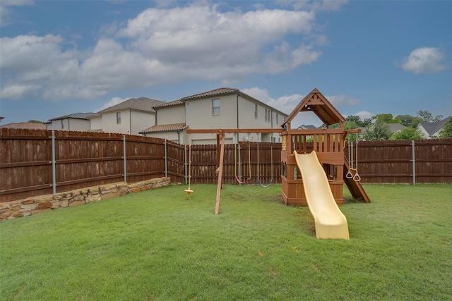 view of play area featuring a lawn and a fenced backyard