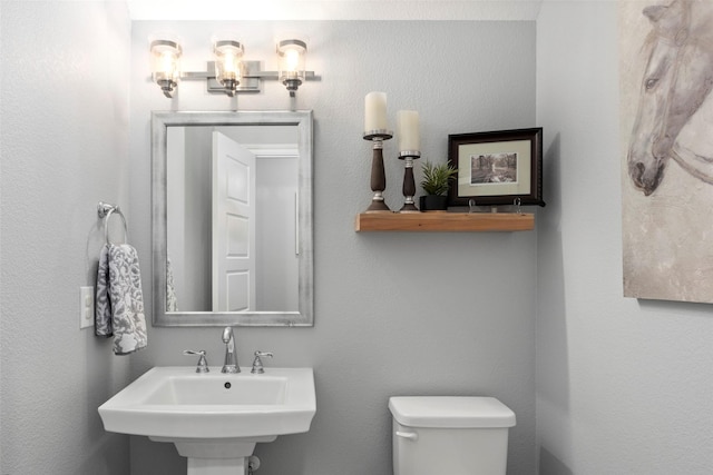 bathroom featuring toilet and a sink