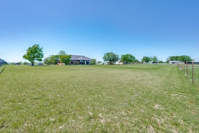 view of yard featuring a rural view and fence