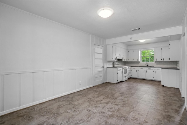 kitchen featuring white range with electric stovetop, a sink, white cabinetry, ornamental molding, and visible vents