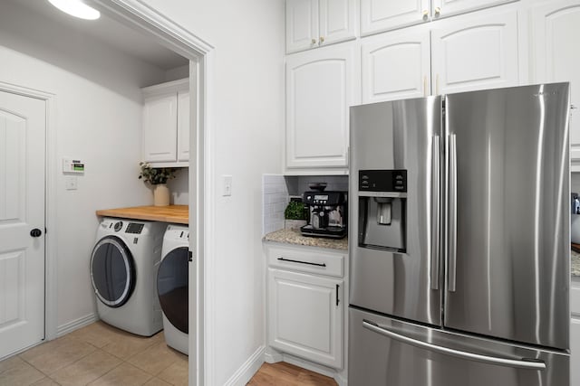 230 Heatherstone Dr, Midlothian, TX 76065 - laundry area featuring cabinet space, washer and clothes dryer, baseboards, and light tile patterned floors