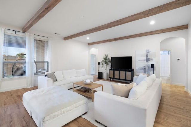 230 Heatherstone Dr, Midlothian, TX 76065 - living room featuring arched walkways, baseboards, beam ceiling, light wood-type flooring, and recessed lighting