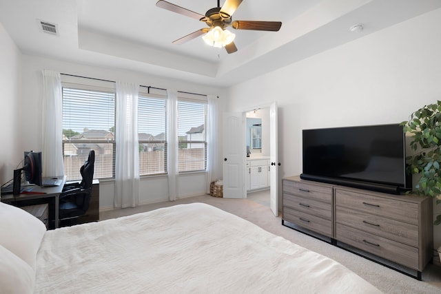 230 Heatherstone Dr, Midlothian, TX 76065 - bedroom with light colored carpet, a raised ceiling, a ceiling fan, and ensuite bathroom