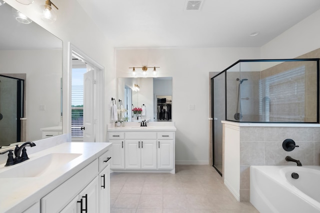 230 Heatherstone Dr, Midlothian, TX 76065 - bathroom featuring a shower stall, two vanities, a bath, and tile patterned floors