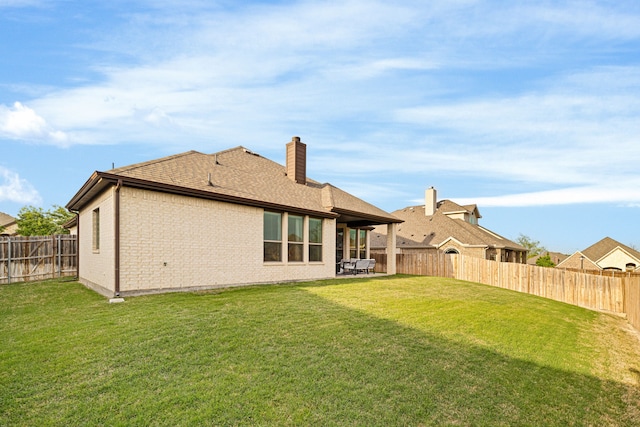 230 Heatherstone Dr, Midlothian, TX 76065 - rear view of house featuring a chimney, brick siding, roof with shingles, and a patio