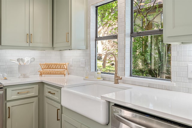 laundry area with a wealth of natural light and a sink
