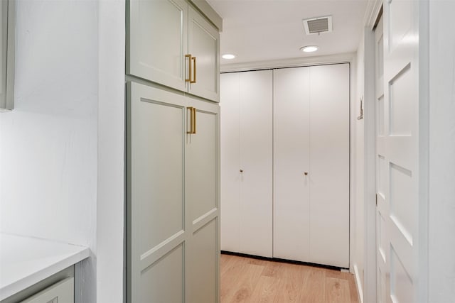 corridor featuring light wood-style floors, visible vents, and recessed lighting