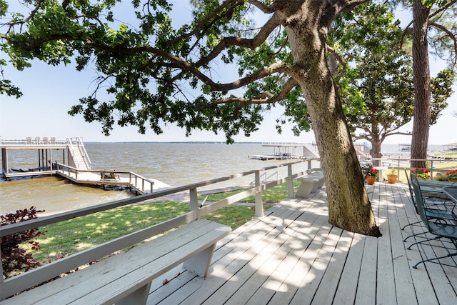 wooden terrace with a dock and a water view