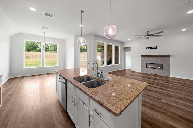14825 Turtle Creek Ranch Rd, Flint, TX 75762 - kitchen featuring a sink, dishwasher, dark wood-style floors, white cabinetry, and a tile fireplace