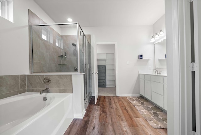 14825 Turtle Creek Ranch Rd, Flint, TX 75762 - full bathroom with vanity, a bath, a stall shower, wood finished floors, and a spacious closet