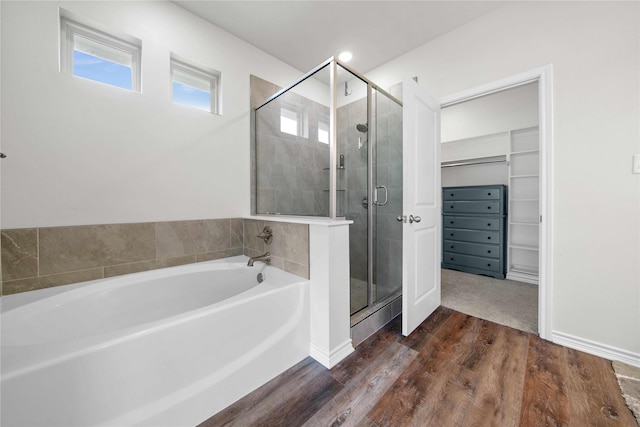14825 Turtle Creek Ranch Rd, Flint, TX 75762 - bathroom featuring a stall shower, a bath, wood finished floors, and a walk in closet