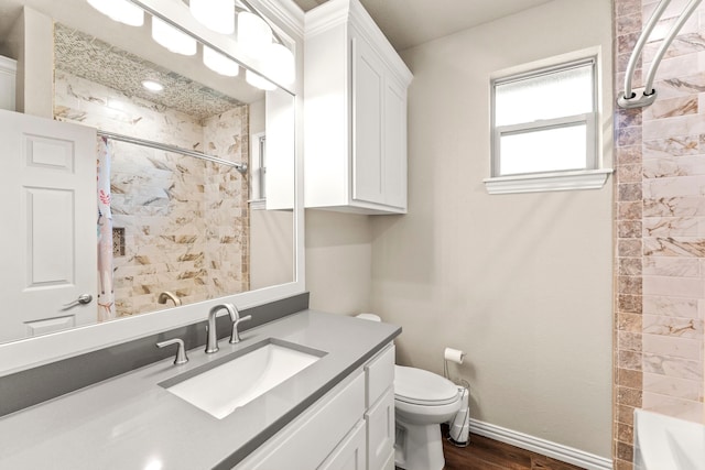 4114 Seminole Trl, Granbury, TX 76048 - full bath featuring toilet, wood finished floors, vanity, and baseboards