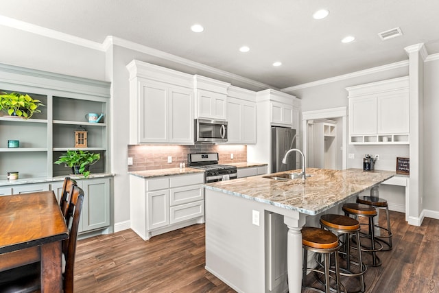 4114 Seminole Trl, Granbury, TX 76048 - kitchen featuring appliances with stainless steel finishes, a sink, open shelves, ornamental molding, and recessed lighting