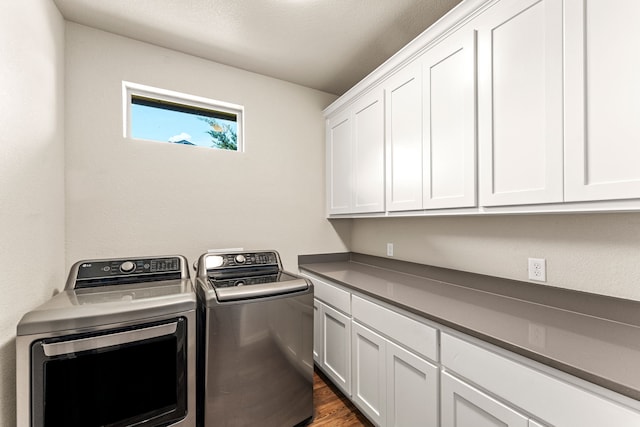 4114 Seminole Trl, Granbury, TX 76048 - laundry room with washing machine and clothes dryer, cabinet space, and dark wood finished floors