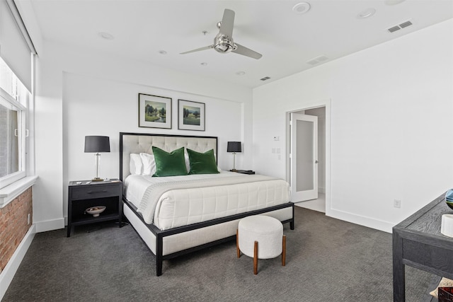 bedroom with dark colored carpet, visible vents, and a ceiling fan