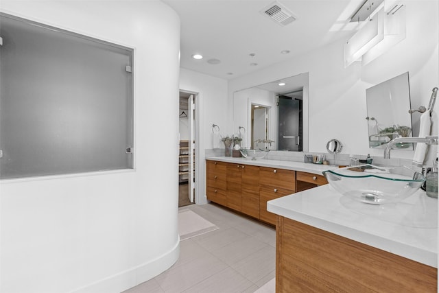 bathroom featuring recessed lighting, tile patterned flooring, double vanity, visible vents, and a sink