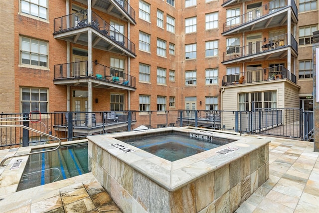 view of pool with a community hot tub