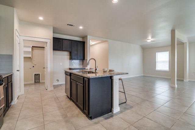kitchen with visible vents, light tile patterned floors, dishwasher, and a sink