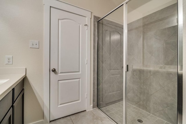 full bath with tile patterned floors, a shower stall, and vanity