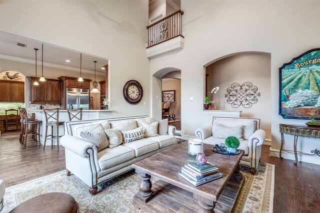 8523 Lakemont Dr, Dallas, TX 75209 - living area featuring arched walkways, baseboards, a high ceiling, wood finished floors, and ornamental molding