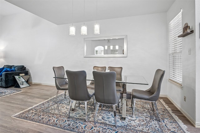 dining room with baseboards and wood finished floors
