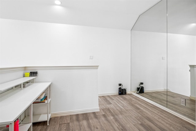 laundry area with baseboards and wood finished floors