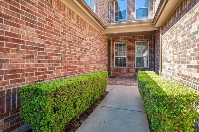 doorway to property with brick siding