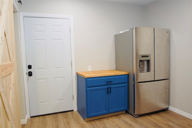 416 Rolling Hills Dr, Aledo, TX 76008 - kitchen with stainless steel fridge with ice dispenser, blue cabinets, light wood-style flooring, butcher block countertops, and baseboards