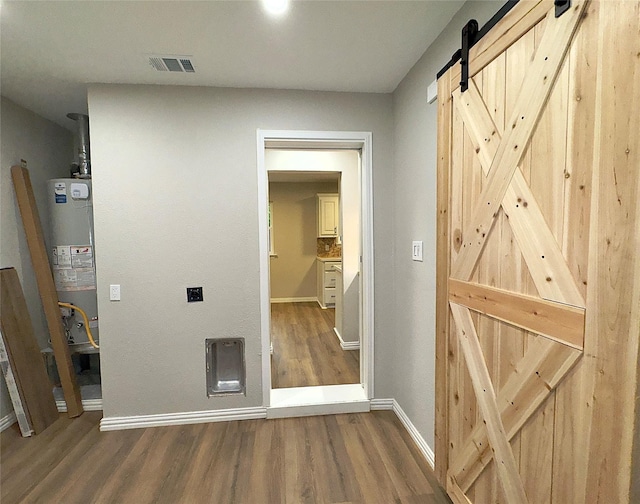 416 Rolling Hills Dr, Aledo, TX 76008 - corridor featuring a barn door, water heater, wood finished floors, and baseboards