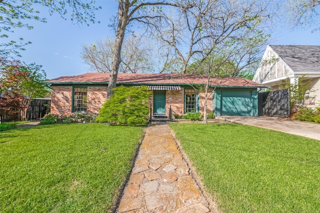 5015 Stoneleigh Ave, Dallas, TX 75235 - single story home featuring a front lawn, driveway, fence, brick siding, and an attached garage