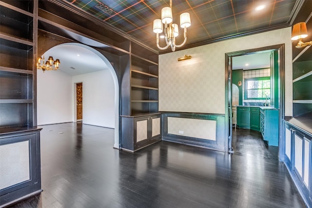 5015 Stoneleigh Ave, Dallas, TX 75235 - unfurnished dining area with crown molding, wood finished floors, a sink, arched walkways, and an inviting chandelier