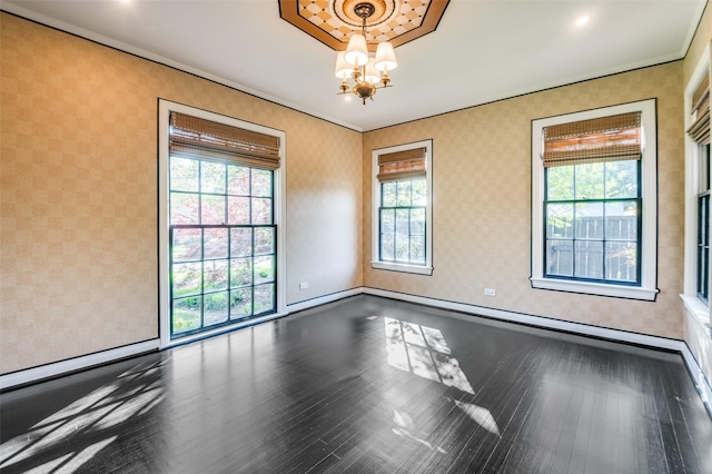 5015 Stoneleigh Ave, Dallas, TX 75235 - spare room with wallpapered walls, wood finished floors, crown molding, baseboards, and a chandelier