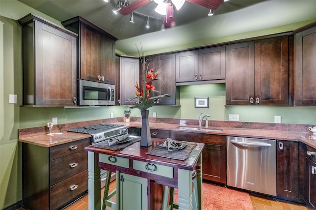 5713 Pershing Ave, Fort Worth, TX 76107 - kitchen featuring appliances with stainless steel finishes, dark brown cabinetry, and a sink