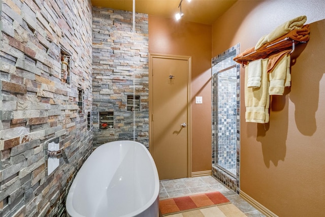 5713 Pershing Ave, Fort Worth, TX 76107 - bathroom with a shower stall, a freestanding bath, and tile patterned flooring