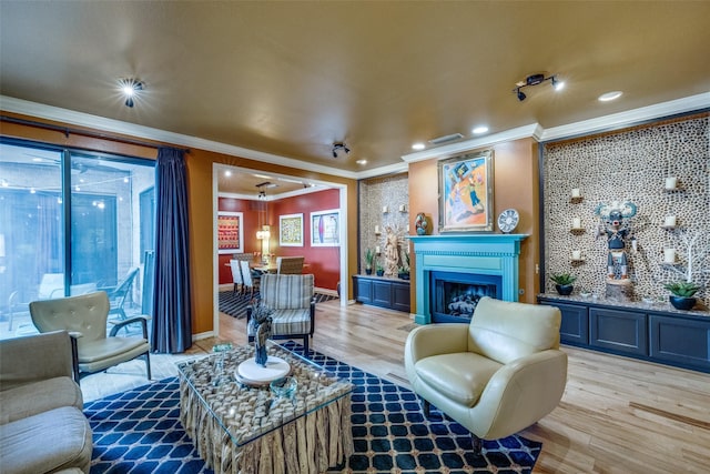5713 Pershing Ave, Fort Worth, TX 76107 - living room featuring light wood finished floors, a glass covered fireplace, recessed lighting, and ornamental molding